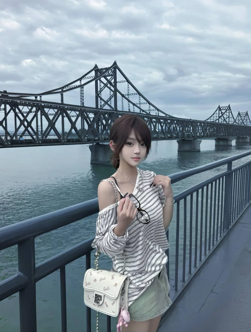 江边大桥前 条纹上衣女孩手拿眼镜