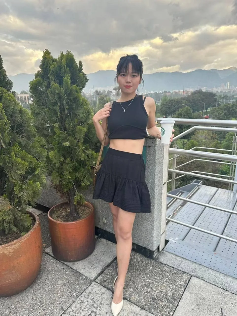 女孩穿黑露脐装倚栏杆